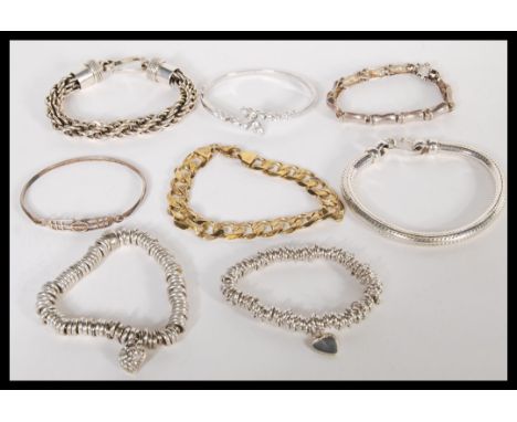 A good group of sterling silver bracelets to include a silver curb link example, large 925 twist bracelet, silver ring bracel