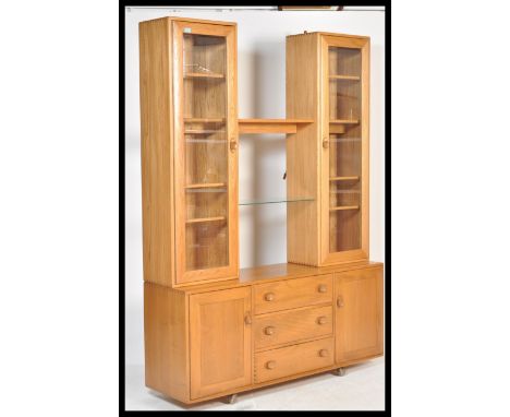 A 20th centuy Ercol beech and&nbsp; elm sideboard dresser&nbsp; shape 455, with two glazed cupboards flanking an open recess 