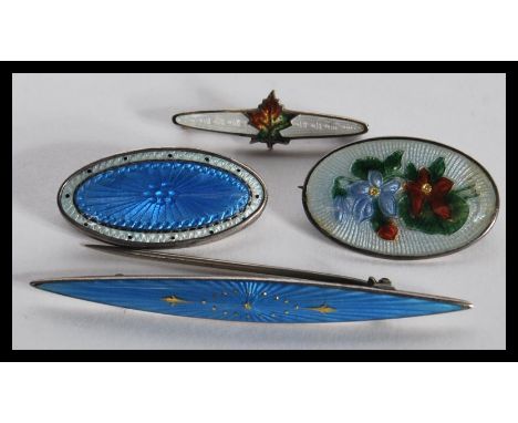 A group of four sterling silver and enamel set danish brooches in the Georg Jensen or Charles Horner style to include a flora