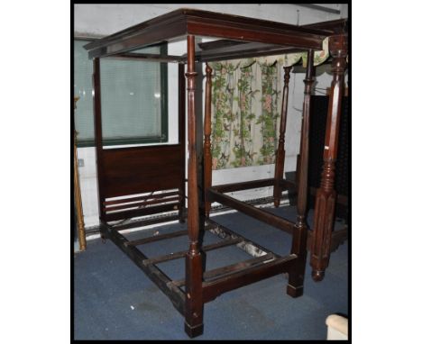 A late Victorian 19th century solid mahogany single four poster bed. The footboard with tall tapering reeded columns having f