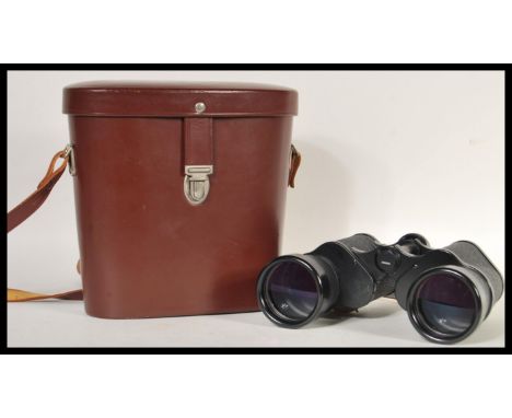 A pair of vintage Carl Zeiss Jena Jenoptem binoculars (10x50 W) in a brown leather case. Measures 20cm high x 22cm width (cas