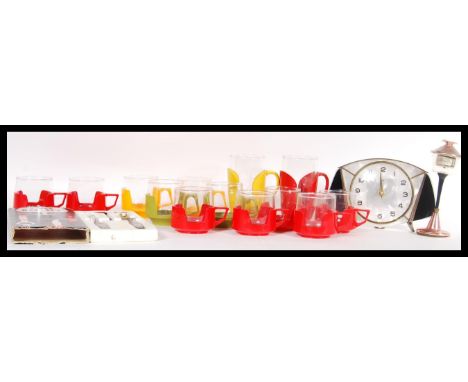A collection of vintage retro 20th Century glass Pyrex drinking cups and mugs, each glass liner with a handled plastic outer 