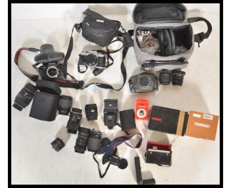 A collection of vintage 20th Century 35mm cameras and lenses to include a Pentax Super F1, Ashai Pentax K1000, Pentax MX, len