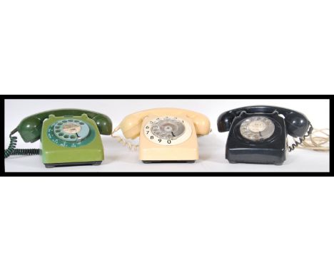 A set of three vintage retro 20th Century bakelite ring dial telephones in cream, green and black colourways.