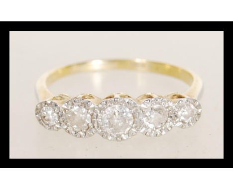 An early 20th century stamped 18ct gold ring illusion set with five brilliant cut diamonds. Estimated approx 30pts of diamond