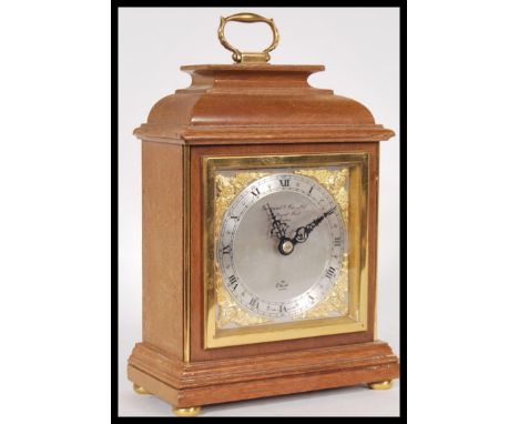 A 20th Century Elliot mantel clock retailed by Garrard &amp; Co Ltd, having a silvered face with roman numerals to the chapte