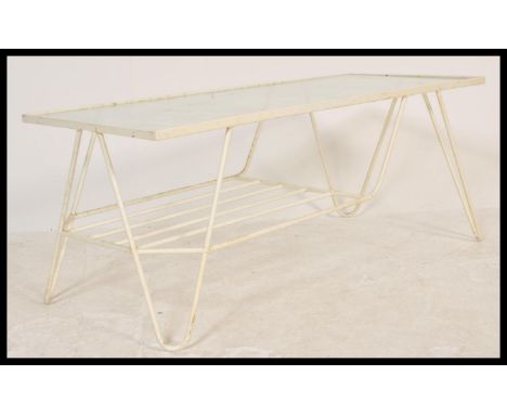 A vintage 20th Century retro Sputnik Atomic two tier coffee table having a glass table top wire shelf below, constructed from