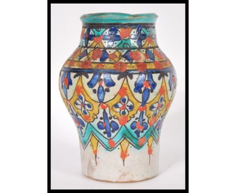 A vintage 20th Century ceramic / pottery Persian baluster vase decorated with fauna details in under-glazed polychrome enamel