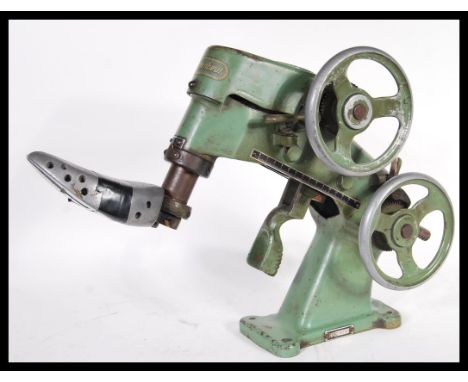 A vintage 20th Century German cast metal Rafflenbeul Euperdus mechanical cobblers shoe repair stretcher having a green enamel