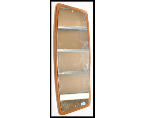 A vintage retro 20th Century teak wood Danish influence wall mirror having a frameless wood back with mirror panel. The wall 
