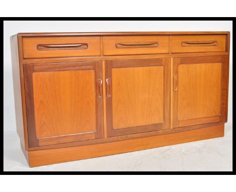 A vintage retro 20th Century G-Plan teak long and low sideboard in the Fresco pattern comprising of three cupboard doors and 