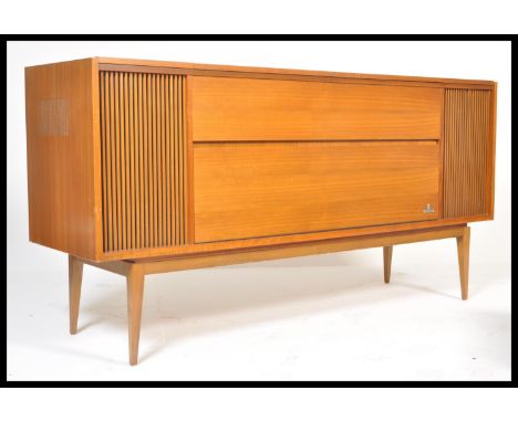 A vintage retro 20th Century teak wood Grundig radiogram having inset Dual 1009 record deck turntable with lift up top and fo