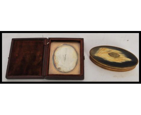 A 19th Century Victorian Daguerreotype portrait photography on metal, depicting a victorian lady in a sitting position holdin