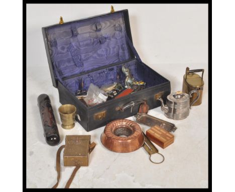 A good collection of vintage curios all contained within a vintage suitcase, the items to include brasswares, tools, small br