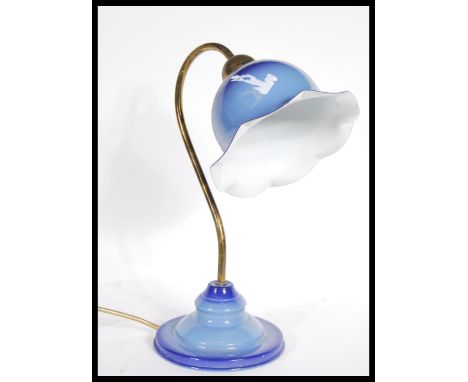 A vintage retro 20th Century enamel table lamp raised on stepped circular base with flared epndant shade and brass shaped arm