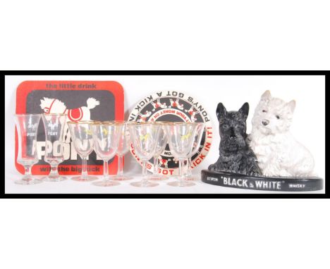 A vintage 20th Century point of sale advertising figure for Black and White Whisky together with a collection of retro advert