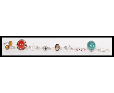 A group of ten sterling silver rings to include carnelian and garnet set ring, large brilliant cut white stone crossover ring