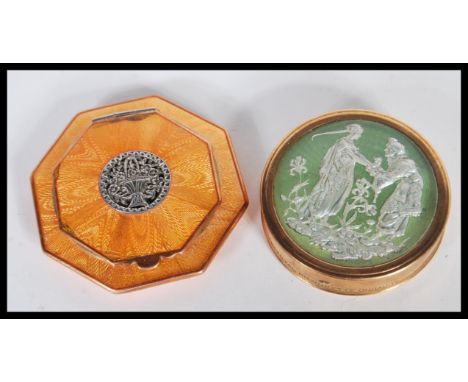 A vintage early 20th Century Art Deco powder mirror compact by Dubarry of circular form having green enamel decoration depict