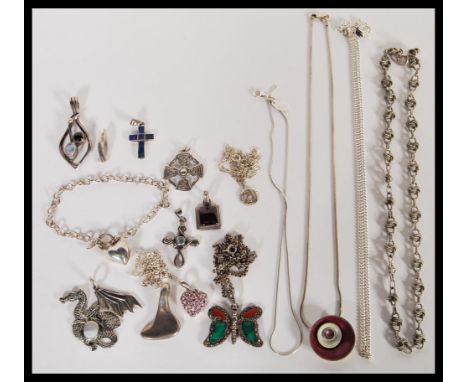 A group of sterling silver necklaces and pendants to include crucifix cross pendants, moonstone pendant, enamel pendant, drag