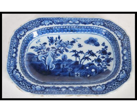A 19th Century Chinese ceramic tray having hand painted blue and white decoration depicting a landscape scene to the central 