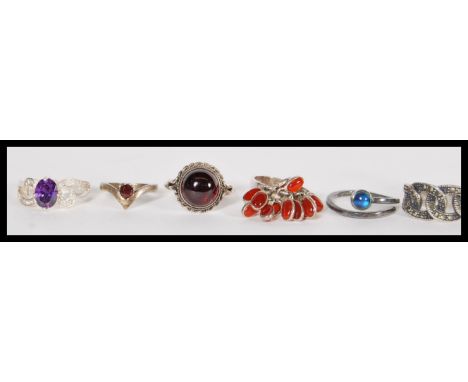 A group of ten sterling silver rings to include blue moonstone crossover ring, amethyst and white stone set ring, carnelian r