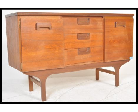 A vintage retro 20th Century teak wood sideboard of small proportions having central bank of three drawers flanked by two cup