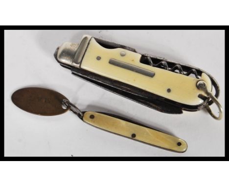 A 20th century vintage pen knife with a bone casing, having a corkscrew and two blades, with a folding fruit knife with a mot
