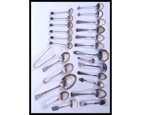 A large collection of hallmarked silver spoons and flatware to include large silver Georgian serving or basting spoon, silver