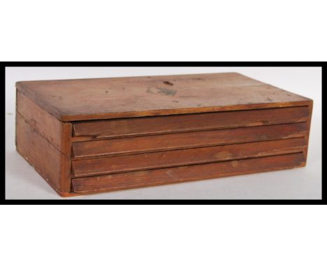A vintage 20th century wooden case of watch parts full of different sized crown winders installed within a watch repairers / 