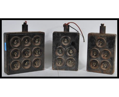 A collection of three vintage 20th Century industrial tin plate and cast iron light switches, the switches coming in two bank