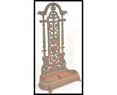 A 19th Century Victorian Coalbrookdale cast iron stick or umbrella stand having tray to lower tier. The back of architectural
