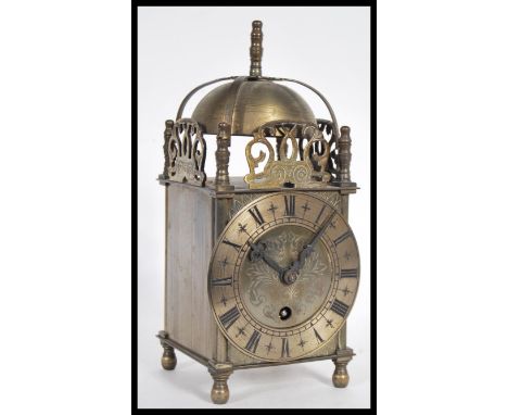 A 19th Century Victorian lantern clock having a pierced frieze with bell to top. The silvered dial having Roman numeral chapt