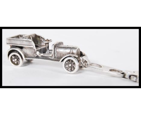 A sterling silver 925 clip pendant in the form of an early 20th Century classic old timer car. Weighs 33.9 grams. Car measure