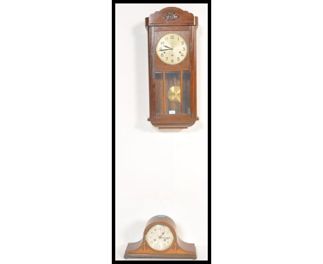 An early 20th Century Edwardian oak cased wall clock, silvered dial together with an inlaid mahogany mantel clock retailed by