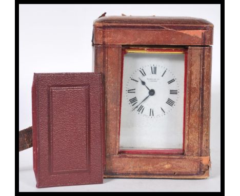 A 19th Century Victorian gilt brass cased carriage clock by Russell Ltd of Liverpool. The white enamel face having Roman nume