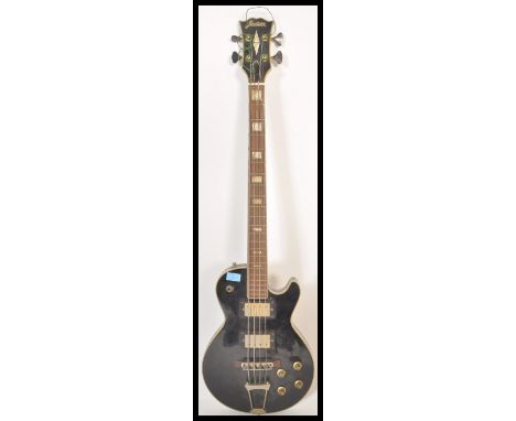 A vintage 1970's Jedson made electric four string bass guitar musical instrument. Black painted Gibson style body, with faux 
