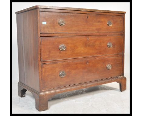 A late 18th / early 19th Century Georgian mahogany chest of drawers consisting of three long graduating drawers fitted with r