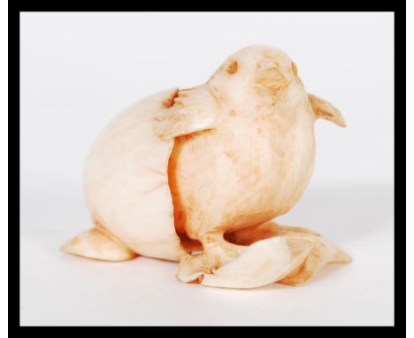 A 19th Century Japanese hand carved ivory netsuke figurine of a chick hatching from an egg. Signed to base. Measures 3 cm hig