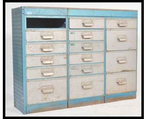 A vintage 20th Century industrial metal filing cabinet having three banks of graduating drawers set within a blue enamelled m