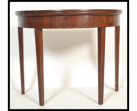 A 19th Century Georgian mahogany line inlay demi lune fold over tea / card games table raised on reeded square tapering&nbsp;