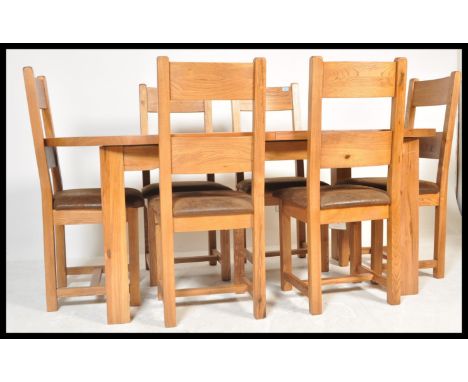 A contemporary large extendable oak dining table in the manner of Oak Furniture land&nbsp; together with a set of six heavy s