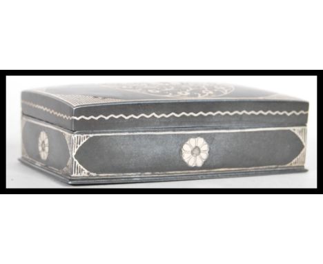 A 19th Century pewter of steel snuff box of rectangular form having silver inlay decoration depicting flowers with line borde