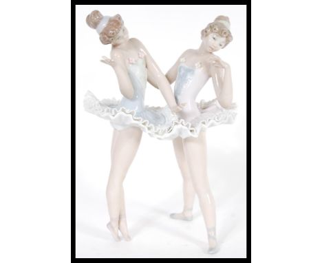 A Lladro ceramic figurine group of Ballerinas entitled Ballet Dress Rehearsal model 05497 complete in original box. Printed a
