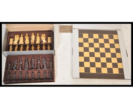 A vintage boxed SAC chess set having ebonised and faux ivory pieces in the medieval style. Complete with board.
