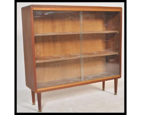 A retro mid 20th century teak wood scratch built glazed fronted bookcase, two full front glazed sliding doors with adjustable