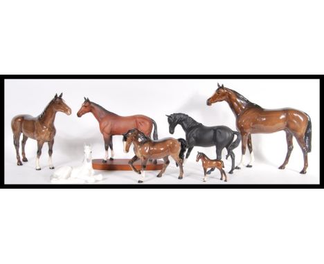 A collection of seven ceramic horses to include Royal Doulton, USSR and Beswick examples, varying in sizes and finishes. Tall