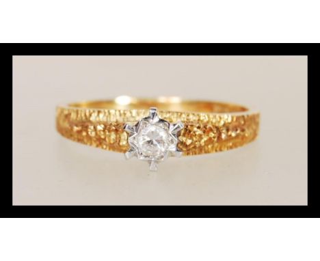 A hallmarked 18ct gold diamond single stone solitaire ring having bark effect band and shoulders with central platinum claw s