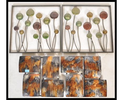 Two pairs of 20th Century wall hanging decorative enamel panels, the first pair constructed within an iron frame and the enam