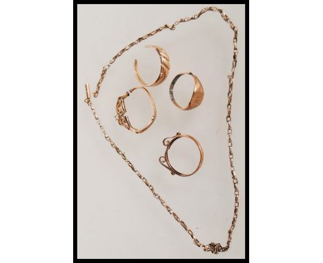 A collection of 9ct gold jewellery to include signet ring, a twist design ring, two coin casings and a necklace chain (Total 