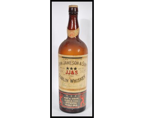 A large vintage retro 20th Century oversized John Jameson &amp; Son Dublin Whisky bottle with original paper label still pres
